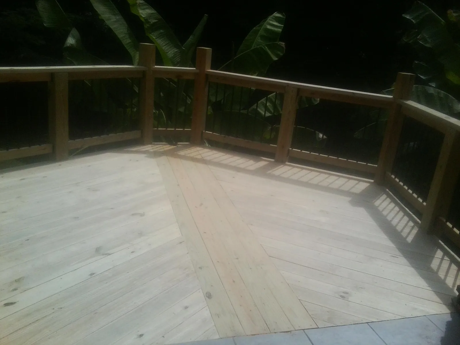 New wood deck and railing built off the back of a home in Mc Alpin