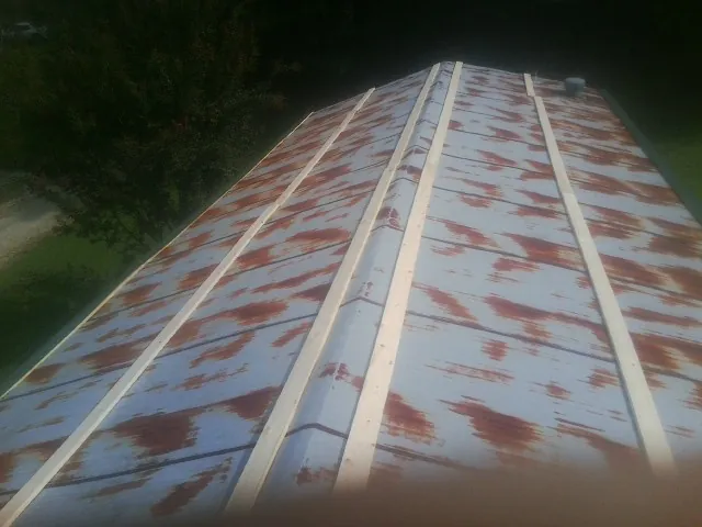 Rusted metal roof panels with new wood purlins before replacement — Storm Damage Roof Repair in Mc Alpin by Roofing Brothers
